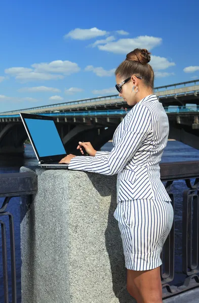 Woman with laptop on quay — Stock Photo, Image