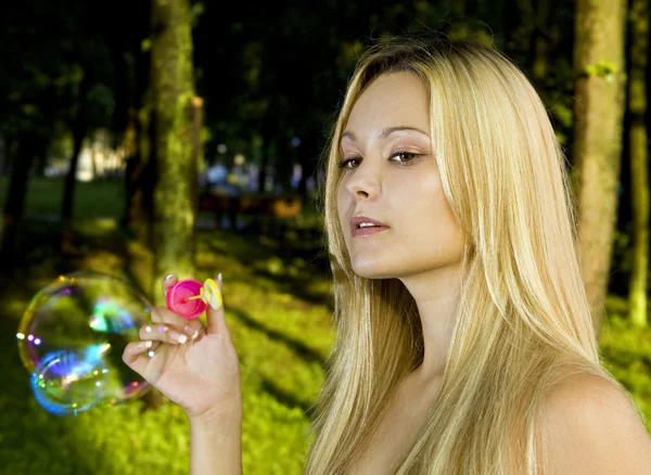 Blonde blowing soap bubbles — Stock Photo, Image