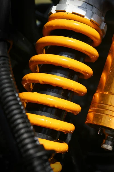 Yellow shock absorber of a quad bike — Stock Photo, Image