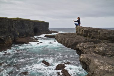 Meditation on the edge of cliff clipart