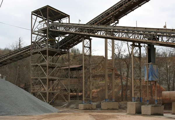 Stone quarry with silos and conveyor — Stock Photo, Image