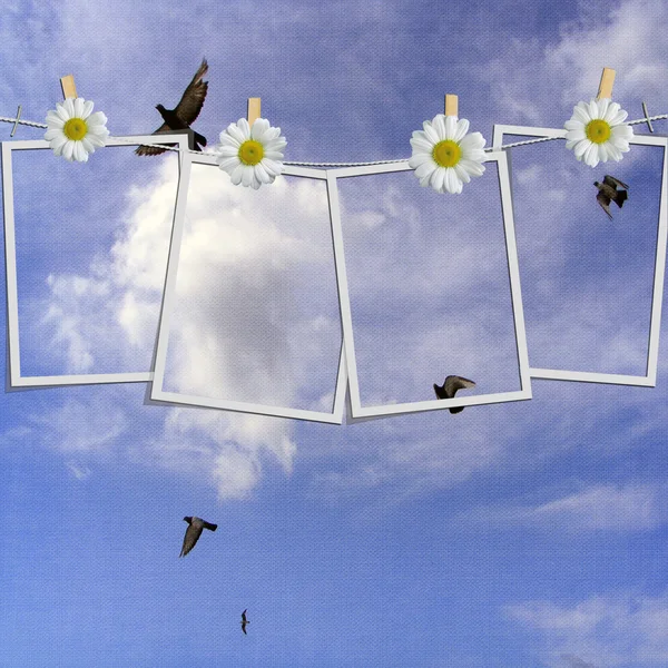 stock image Polaroid photos hanging on a rope against blue sky