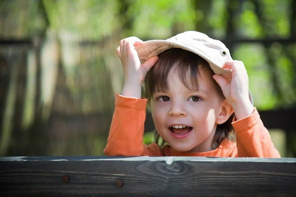 Playful child holding his hat — Stock Photo, Image