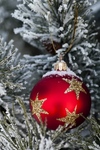Snow on red christmas bauble — Stock Photo, Image