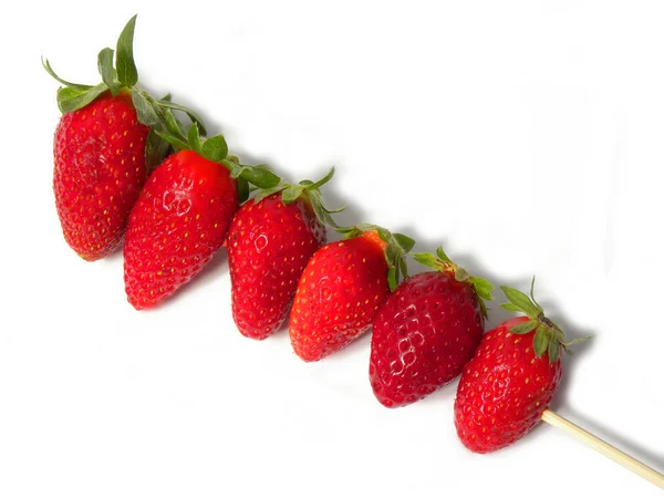 Strawberries on a wooden stick — Stock Photo, Image