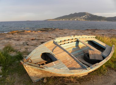 Old boat on the beach clipart