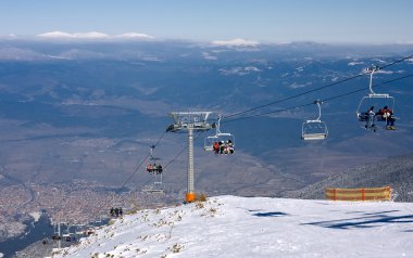 Chair ski lift over mountain landscape clipart