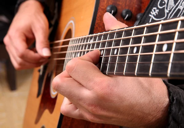 Hands playing guitar in diagonal position