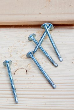 Five screws on wood planks clipart