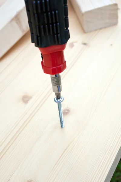 Screwdriver, screw and wood planks — Stock Photo, Image