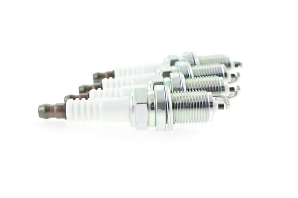 Quatro velas de ignição em um fundo branco — Fotografia de Stock