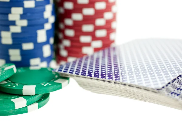 Three color poker chip stacks and cards deck — Stock Photo, Image