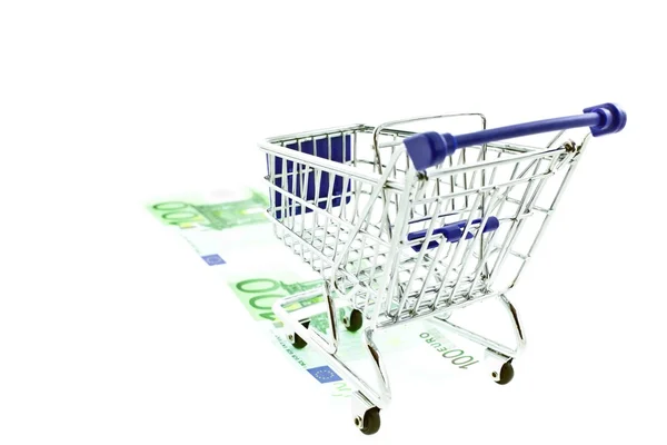 Shopping trolley on 100 euro notes isolated — Stock Photo, Image