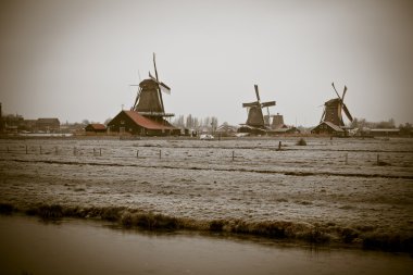 Sepia toned image of windmills in Zaanse Schans clipart