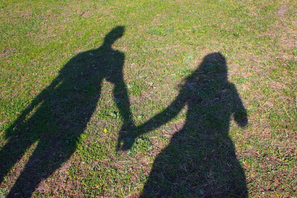 Shadows of friends on the grass — Stock Photo, Image