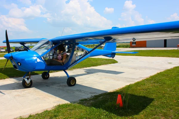 stock image Small blue airplane under sky