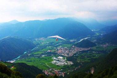 Hang glider flying in the Alps clipart