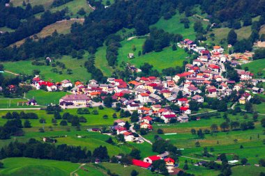Small town in the mountains in Slovenia clipart