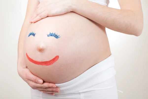 Drawing persons on pregnant belly — Stock Photo, Image