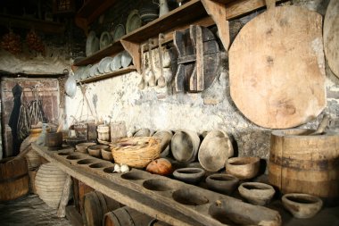 Antiquarian tableware in old kitchen. clipart