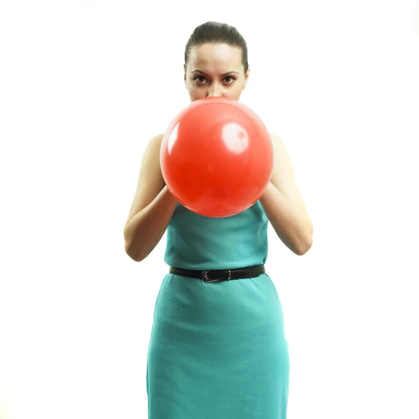 Young girl inflating a balloon — Stock Photo, Image