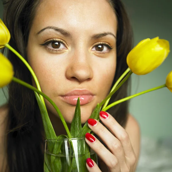 Mladá žena s kyticí tulipánů — Stock fotografie