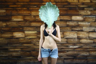 Young woman with cabbage leaf mask clipart