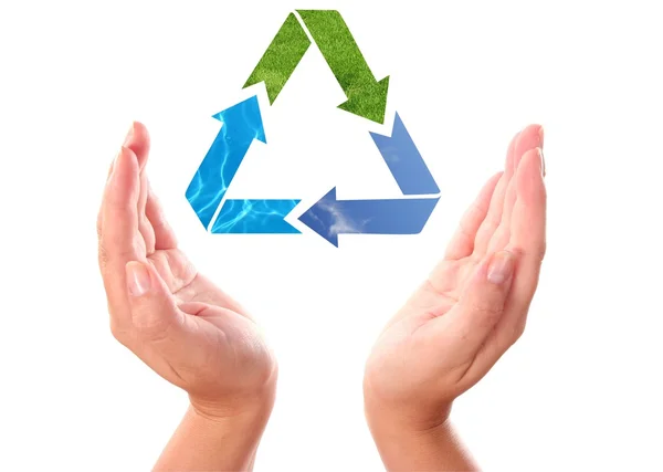 Recycling arrow symbol between human hands — Stock Photo, Image