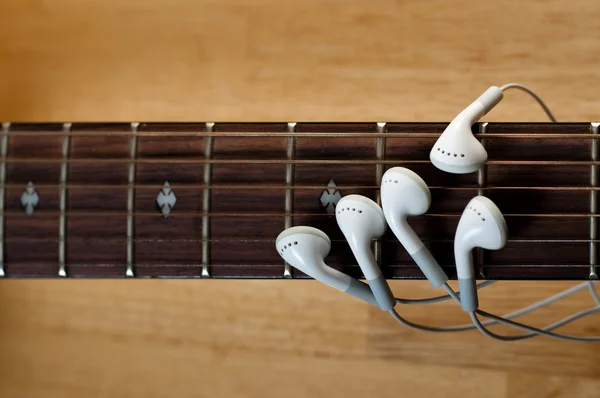 stock image Earbuds as Fingers on Guitar