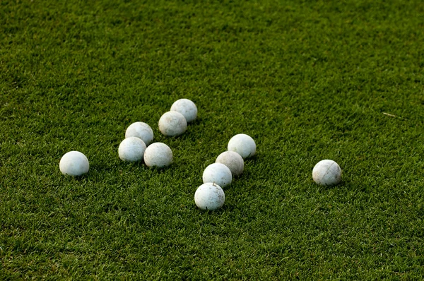 Many lacrosse balls on green grass — Stock Photo, Image