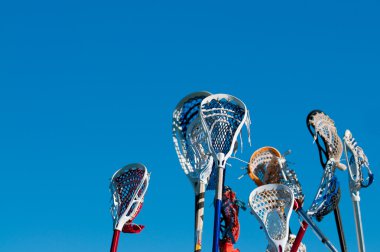 Many lacrosse sticks in the air clipart