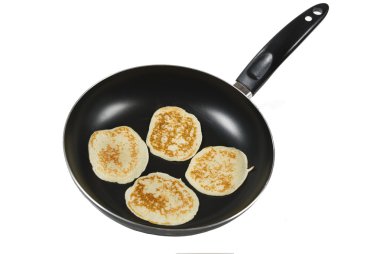 A luscious pancake cooking in a pan clipart