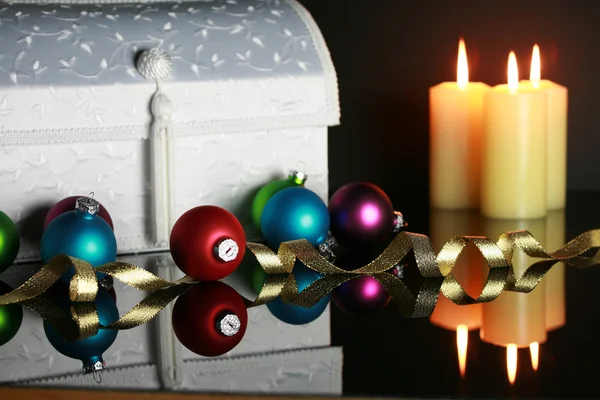 Christmas ornaments and lit candles — Stock Photo, Image