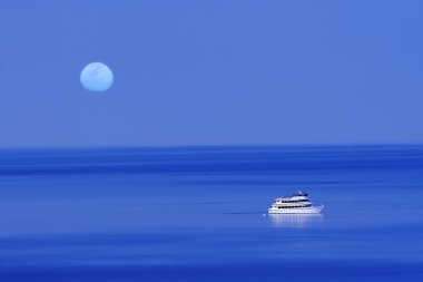 Moon over blue lake with boat clipart