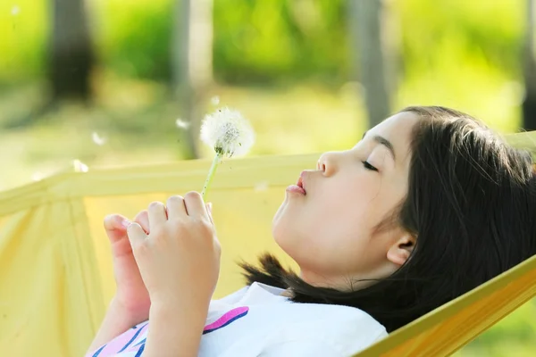 Child blowing dandelion — Stock Photo, Image