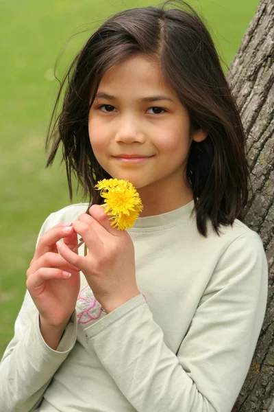 Girl holding dandelions — Stock Photo, Image