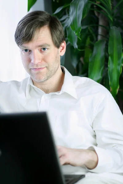Handsome businessman working on laptop — Stock Photo, Image