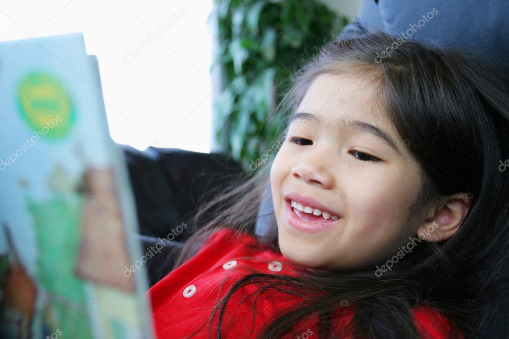 Child happily reading a book