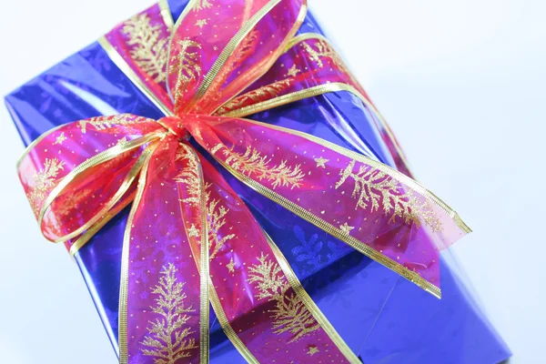 Elegant dark blue present wrapped with red ribbo — Stock Photo, Image