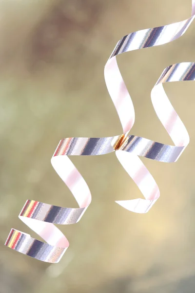 Gold satin ribbons curled elegantly, holiday par — Stock Photo, Image