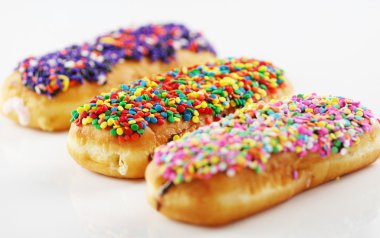 Three delicious colorful donuts clipart