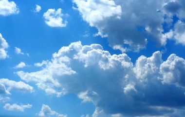 Bright blue skies and fluffy white clouds clipart