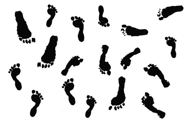 Black silhouette outlines of actual children's footprints on whi — Stock Photo, Image