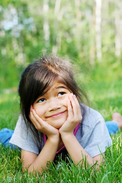 Kind auf Gras liegend — Stockfoto