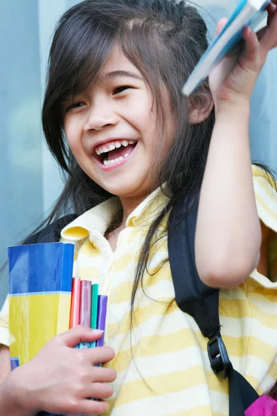 Meisje enthousiast over haar nieuwe schoolboeken — Stockfoto