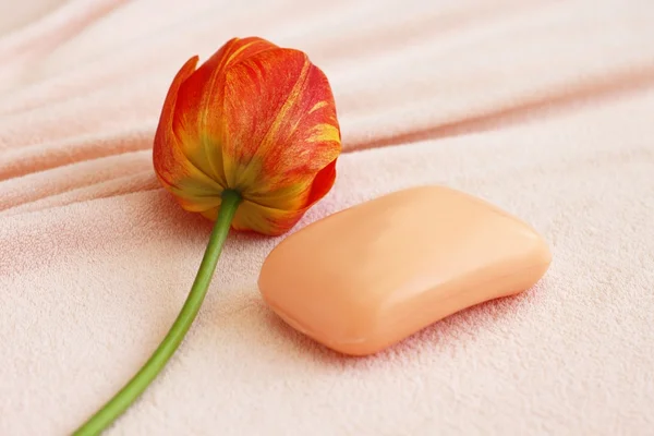 Soap with tulip on towel — Stock Photo, Image