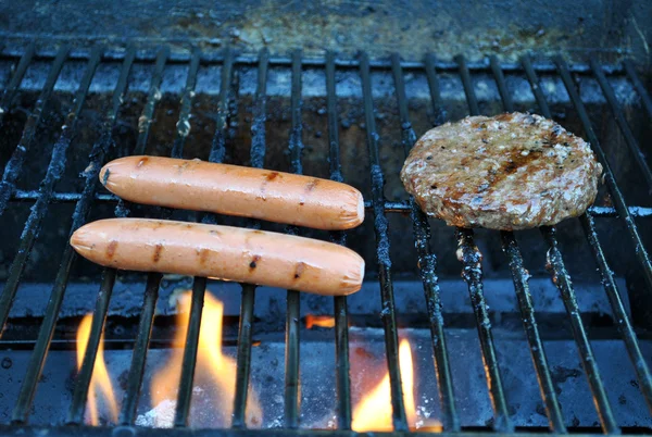 stock image Hotdogs and hamburger grilling