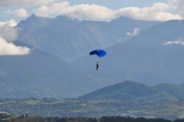 Mountain and the parachutist. clipart