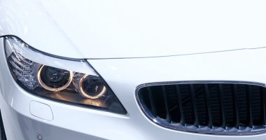 Headlights of new white car clipart