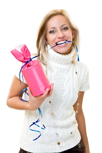 Beautiful young woman bites a gift — Stock Photo, Image